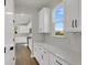 Hallway with ample storage and white cabinets leading to the kitchen at 5206 Cottage Lndg Dr, Summerville, SC 29485