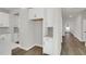 Hallway leading to the kitchen with ample storage and white cabinets at 5206 Cottage Lndg Dr, Summerville, SC 29485