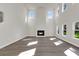 Bright and open living room with a fireplace, expansive windows, and tall ceilings, creating an airy atmosphere at 5206 Cottage Lndg Dr, Summerville, SC 29485