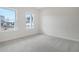 A carpeted bedroom with natural light from the two windows that overlook the community at 5213 Cottage Lndg Dr, Summerville, SC 29485