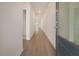 Bright hallway featuring hardwood floors and neutral paint, leading to living spaces at 5213 Cottage Lndg Dr, Summerville, SC 29485