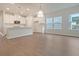 Open-concept kitchen featuring white cabinetry, modern lighting, and a large breakfast bar at 5213 Cottage Lndg Dr, Summerville, SC 29485
