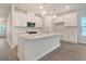 Modern kitchen with white cabinets, stainless steel appliances, and a central island at 5213 Cottage Lndg Dr, Summerville, SC 29485
