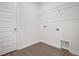 Well-lit laundry room with wood-look floors and wire shelving above washer/dryer connections at 5213 Cottage Lndg Dr, Summerville, SC 29485