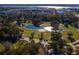Aerial view of a picturesque park with a pond, lush greenery, and walking paths in a vibrant urban setting at 71 Moultrie St, Charleston, SC 29403