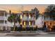 Charming two-story home with inviting balconies, warm lighting, and well-manicured landscaping at twilight at 71 Moultrie St, Charleston, SC 29403