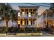 Charming two-story home with double porches, black shutters, fenced yard, and a well-lit entry at 71 Moultrie St, Charleston, SC 29403