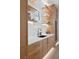 Close up of a modern kitchen featuring wooden cabinets, marble countertops, shelving and sleek faucet at 71 Moultrie St, Charleston, SC 29403