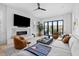 Cozy living room with a marble fireplace, comfortable seating, and a large window with plantation shutters at 71 Moultrie St, Charleston, SC 29403