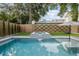Beautiful swimming pool with a spa and modern waterfall feature in a well-maintained backyard at 71 Moultrie St, Charleston, SC 29403