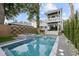 Stunning swimming pool with a jacuzzi surrounded by lush landscaping and a charming two-story home at 71 Moultrie St, Charleston, SC 29403