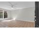 Living room with tile flooring, neutral color paint, ceiling fan and ample natural light at 867 Colony Dr # F-82, Charleston, SC 29407