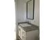 A bathroom vanity features a gray granite countertop, rectangle mirror, and white cabinets at 8833 Cottageville Hwy, Cottageville, SC 29435
