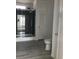 Bathroom showcasing a modern glass-enclosed shower with neutral tile and a nearby toilet at 8833 Cottageville Hwy, Cottageville, SC 29435