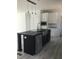 Elegant kitchen island featuring a sink, dishwasher, and modern lighting for a functional workspace at 8833 Cottageville Hwy, Cottageville, SC 29435