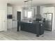 Bright kitchen with stainless steel appliances, an island, and white cabinets for a contemporary aesthetic at 8833 Cottageville Hwy, Cottageville, SC 29435