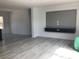 Spacious living room with stylish flooring and a modern entertainment center for a comfortable space at 8833 Cottageville Hwy, Cottageville, SC 29435