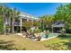 Expansive backyard with a sparkling pool, patio, lush greenery, and an inviting outdoor oasis at 935 Royall Ave, Mount Pleasant, SC 29464