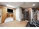 Finished basement area featuring a television, shelving, and workout equipment at 935 Royall Ave, Mount Pleasant, SC 29464