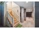 Basement stairs with painted wood and a railing leading into a finished basement with support beams and concrete floor at 935 Royall Ave, Mount Pleasant, SC 29464