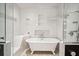 Bright, well-lit bathroom featuring a clawfoot tub and a separate glass shower at 935 Royall Ave, Mount Pleasant, SC 29464