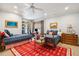 Comfortable bedroom with two beds, ceiling fan, a red rug, and ample natural light at 935 Royall Ave, Mount Pleasant, SC 29464
