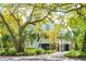 Beautiful two-story home with a charming front porch, surrounded by mature trees and lush landscaping at 935 Royall Ave, Mount Pleasant, SC 29464