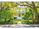 Charming two-story home with a welcoming front porch, lush landscaping, and mature trees providing ample shade at 935 Royall Ave, Mount Pleasant, SC 29464