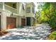 Spacious three-car garage with a concrete driveway, surrounded by mature trees and lush landscaping at 935 Royall Ave, Mount Pleasant, SC 29464