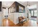 Hallway with dark walls, white wainscoting, hardwood floors, and decorative artwork at 935 Royall Ave, Mount Pleasant, SC 29464