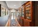 Long hallway with hardwood floors, a decorative rug, and a custom built-in bookcase at 935 Royall Ave, Mount Pleasant, SC 29464