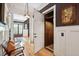 Hallway with stylish wood floors, white wainscoting, dark walls, and an in-home elevator at 935 Royall Ave, Mount Pleasant, SC 29464