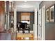 Elegant hallway featuring hardwood floors, dark gray walls, white trim, and a grand piano in view at 935 Royall Ave, Mount Pleasant, SC 29464