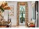 Inviting hallway with hardwood floors, floral curtains, and framed artwork at 935 Royall Ave, Mount Pleasant, SC 29464