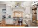 Well-equipped kitchen with a professional-grade range, custom hood, and designer backsplash at 935 Royall Ave, Mount Pleasant, SC 29464