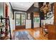 Elegant living room featuring hardwood floors, wainscoting, tall ceilings, and abundant natural light at 935 Royall Ave, Mount Pleasant, SC 29464