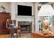 Cozy living room showcasing a fireplace with a granite surround and built-in shelving at 935 Royall Ave, Mount Pleasant, SC 29464