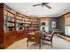 Home office with custom wood bookshelves, a leather desk, and a comfortable seating area at 935 Royall Ave, Mount Pleasant, SC 29464