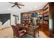 Large office space with custom bookshelves, a mahogany desk, a ceiling fan, and a comfortable leather chair at 935 Royall Ave, Mount Pleasant, SC 29464