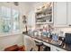Bright office nook featuring custom white cabinets, granite countertops, and a cozy chair at 935 Royall Ave, Mount Pleasant, SC 29464