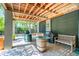 Outdoor grilling area with brick flooring, wooden beams, a wooden barrel table, and various grilling equipment at 935 Royall Ave, Mount Pleasant, SC 29464