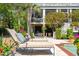 Luxurious patio area with chaise lounges, plush cushions, and outdoor furniture perfect for relaxation by the pool at 935 Royall Ave, Mount Pleasant, SC 29464