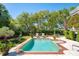 Inviting backyard pool surrounded by lush landscaping and lounge chairs, creating a serene retreat at 935 Royall Ave, Mount Pleasant, SC 29464