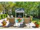 Relaxing poolside view with lounge chairs, vibrant flowers, and a charming cabana for ultimate comfort and leisure at 935 Royall Ave, Mount Pleasant, SC 29464