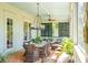 Inviting screened-in porch featuring a dining area and comfortable seating for relaxing and entertaining at 935 Royall Ave, Mount Pleasant, SC 29464