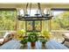 Close up on a dining table with plants and patio views beyond the porch at 935 Royall Ave, Mount Pleasant, SC 29464