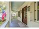 Inviting front porch with classic columns, wood floors, and views of lush greenery at 935 Royall Ave, Mount Pleasant, SC 29464