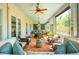 Spacious screened-in porch with comfortable seating, ceiling fans, and outdoor dining area at 935 Royall Ave, Mount Pleasant, SC 29464