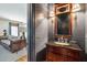 Elegant powder room with a dark wood vanity and decorative mirror at 935 Royall Ave, Mount Pleasant, SC 29464