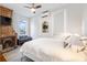 Cozy bedroom with a brick fireplace and a comfortable bed, illuminated by natural light from the large window at 1 Percy St, Charleston, SC 29403